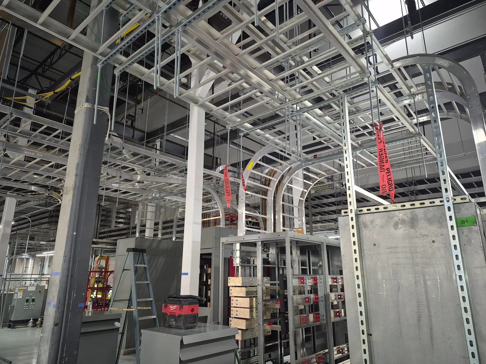 Overhead conduit and cable routing inside an industrial facility